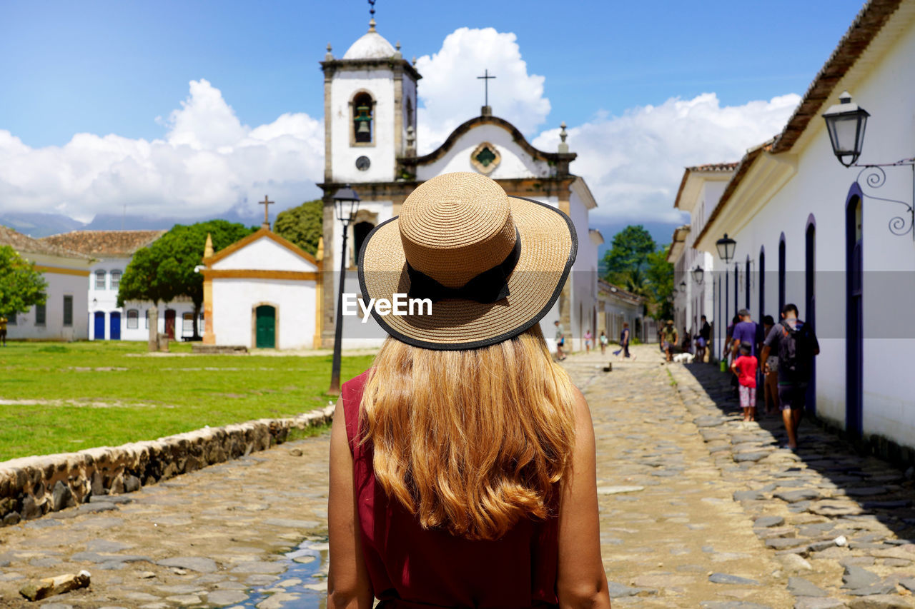 Tourism in brazil. young woman visiting the historic town of paraty, rio de janeiro, brazil.