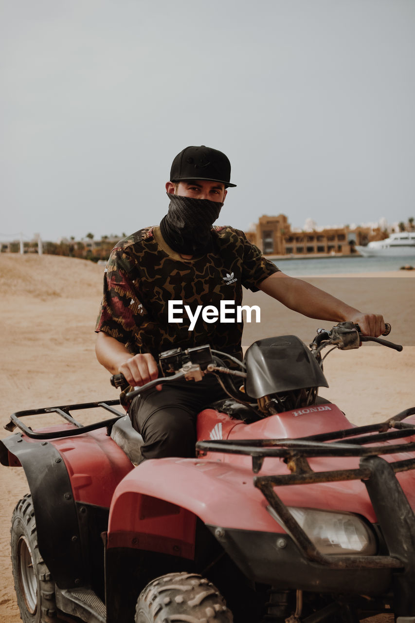 YOUNG MAN RIDING MOTORCYCLE