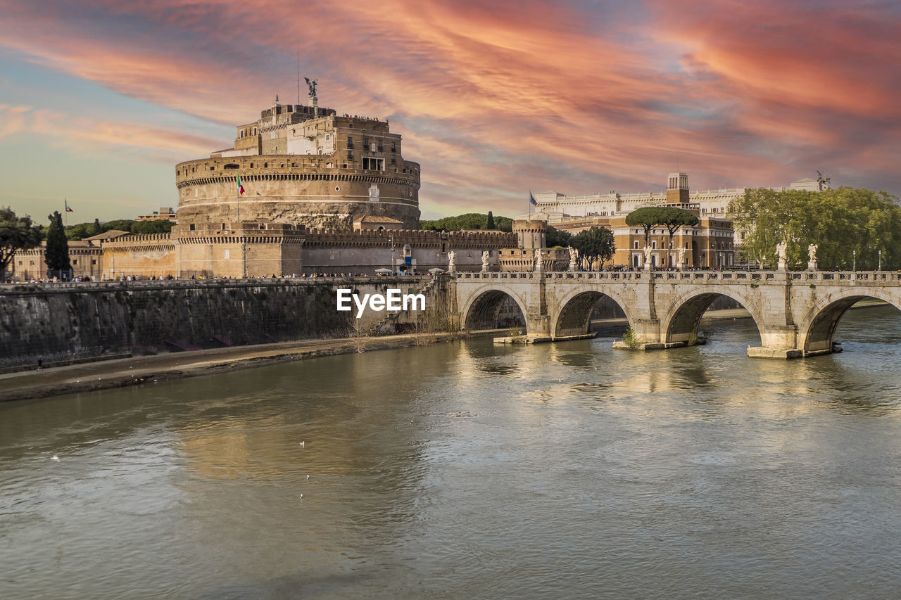 Tevere river and castle sant'angelo in rome with a spectacular sky