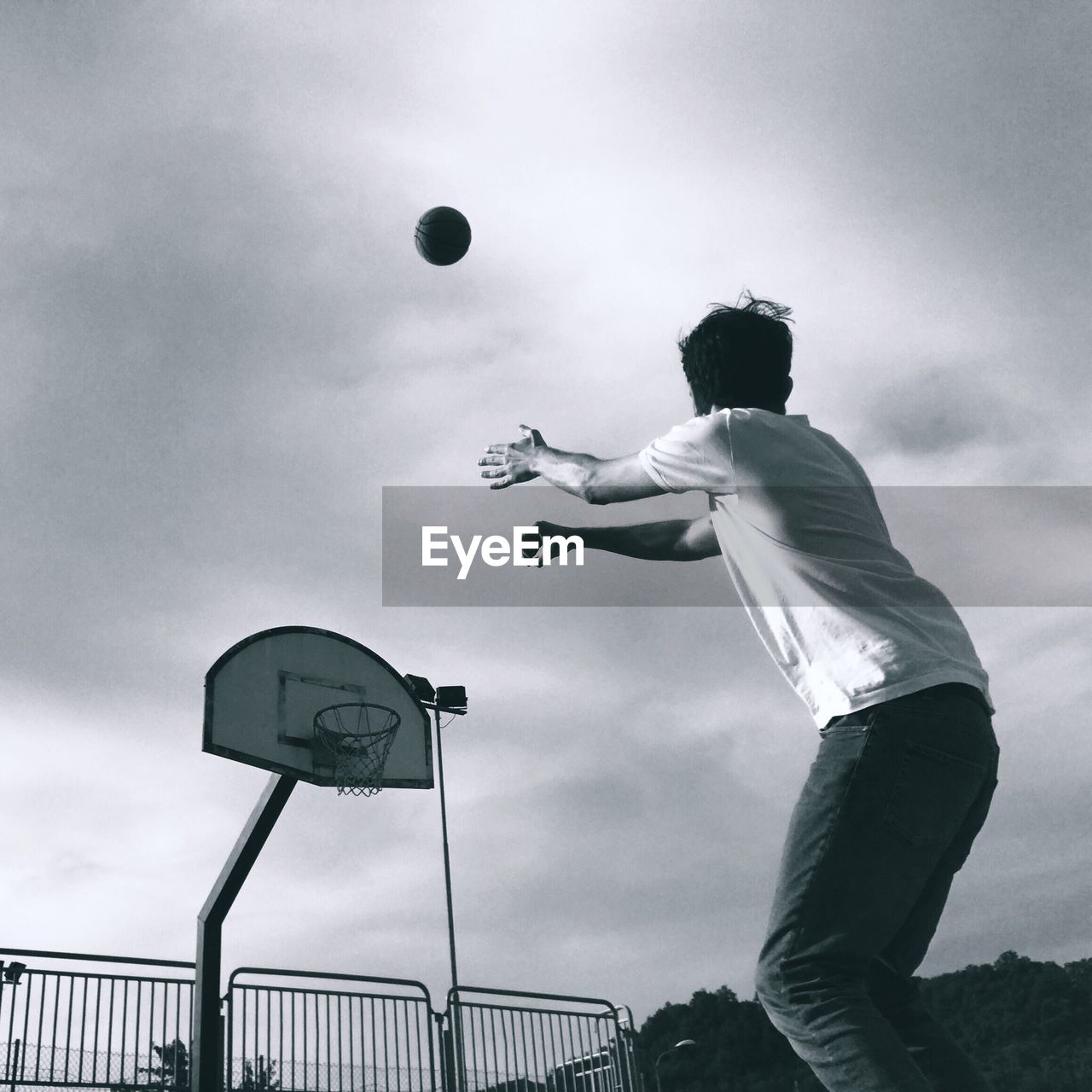 Low angle view of man playing basketball at court