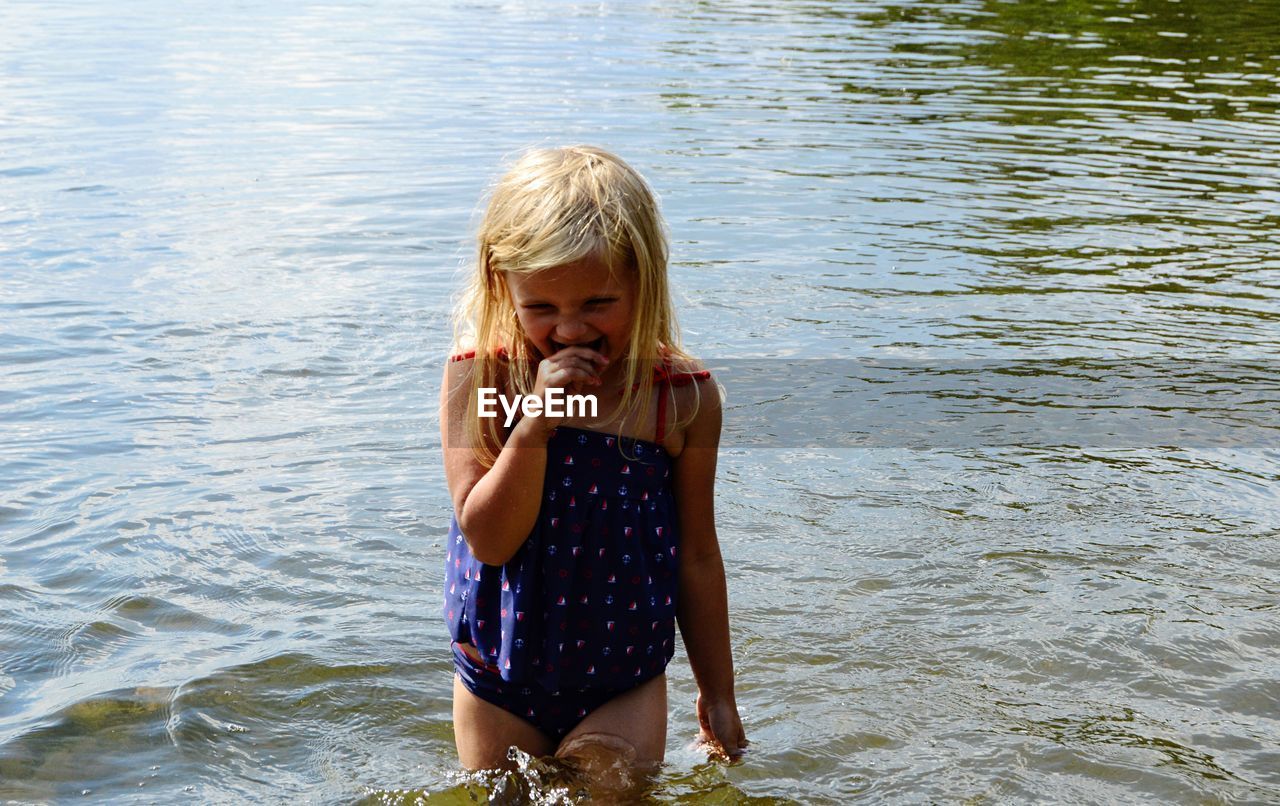 Girl standing in lake