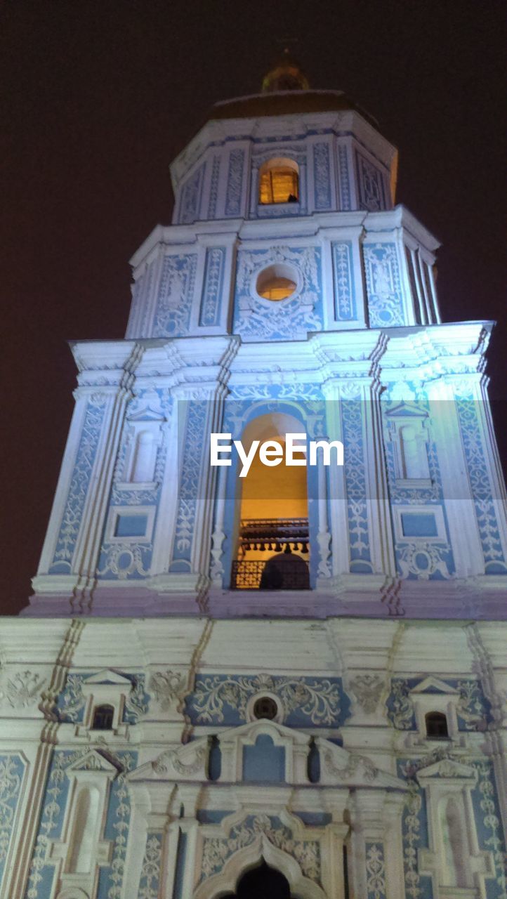 LOW ANGLE VIEW OF HISTORIC TEMPLE AT NIGHT