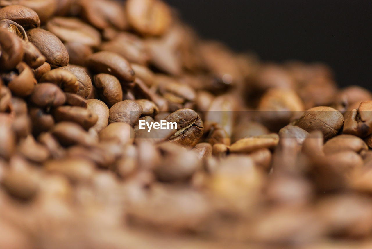 CLOSE-UP OF COFFEE BEANS IN CONTAINER