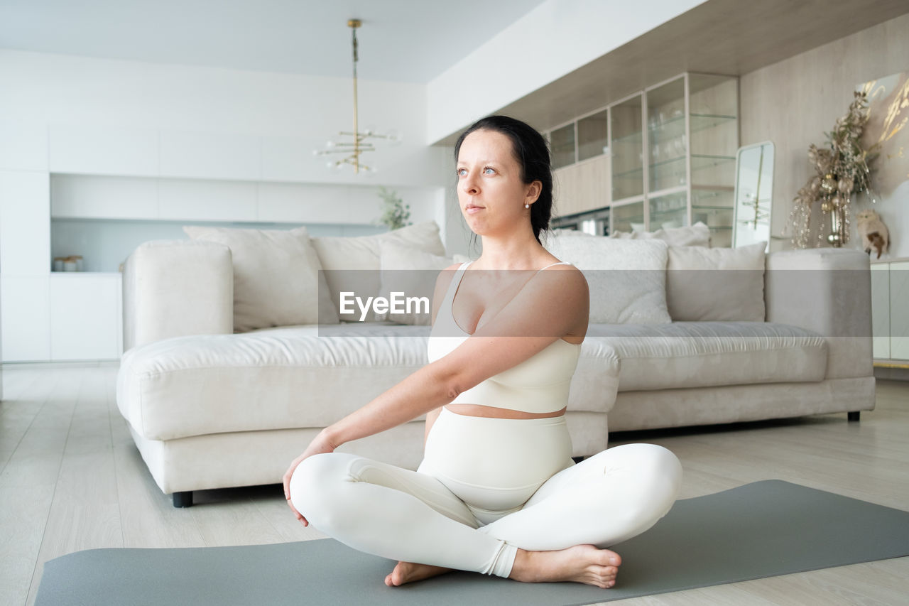 Pregnant woman meditating at home