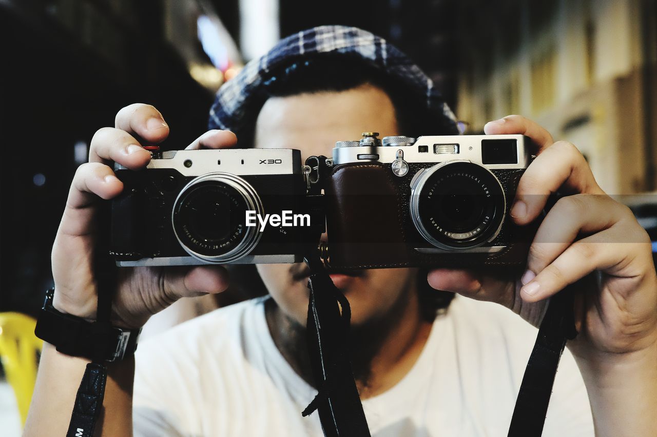 CLOSE-UP OF MAN PHOTOGRAPHING