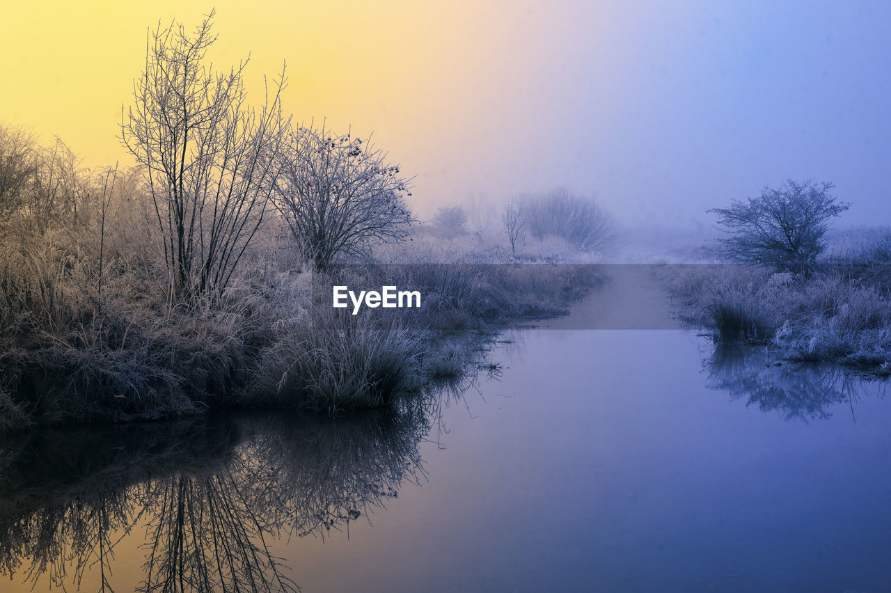 Beautiful winter sunrise and fog on river