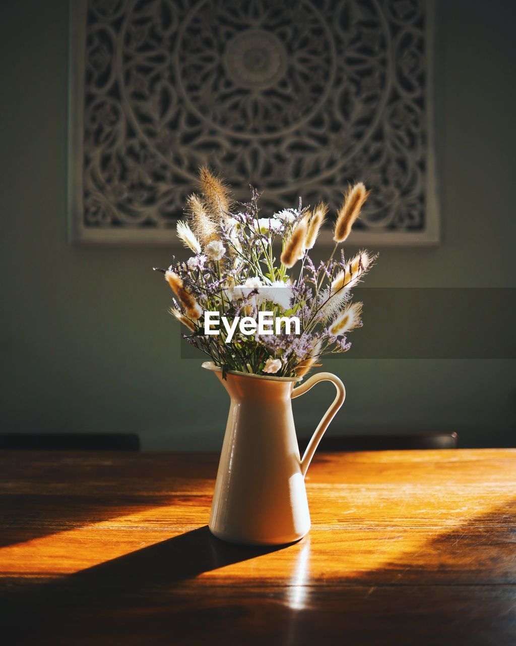 Close-up of flower vase on table at home