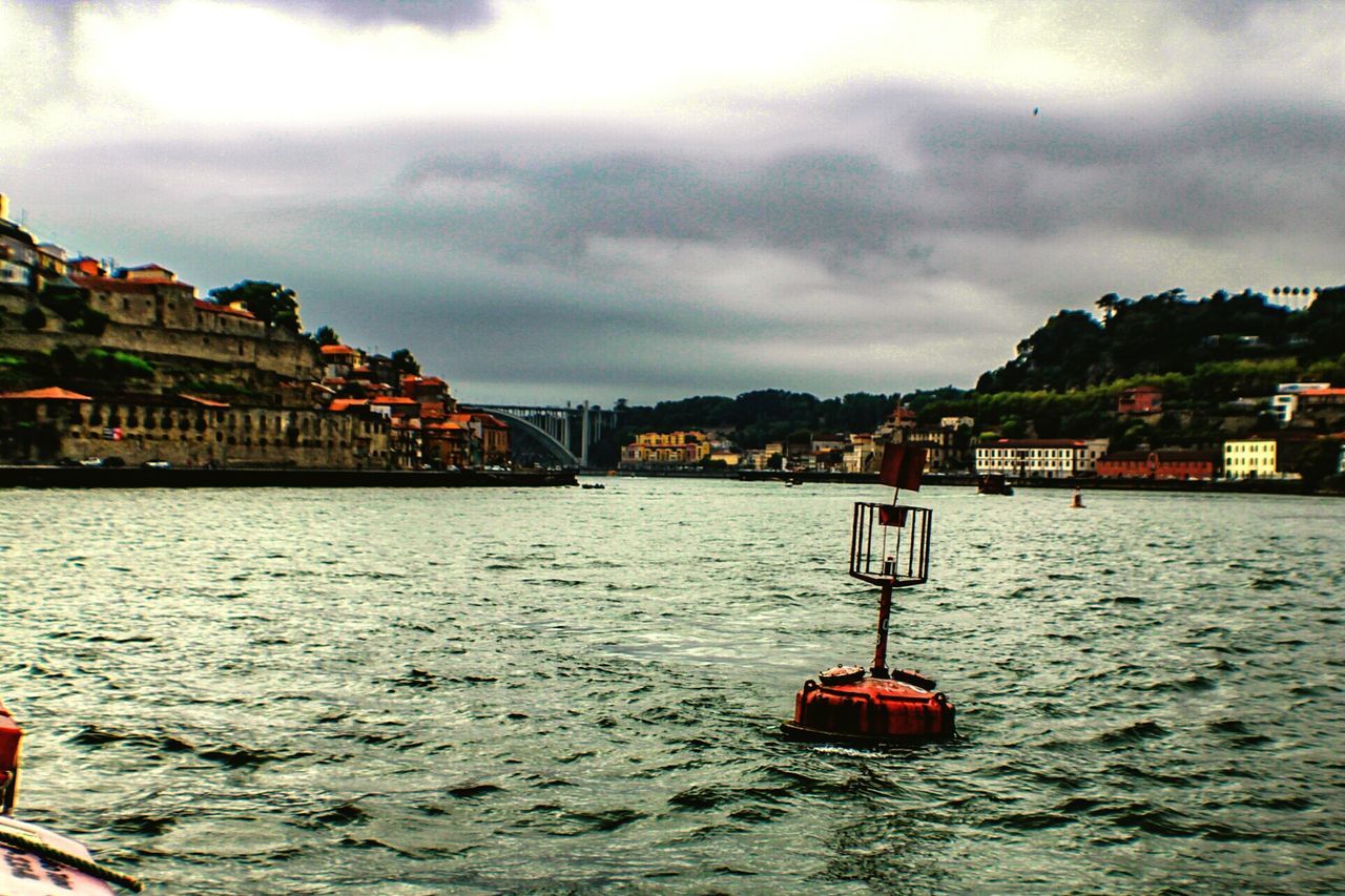 VIEW OF BOAT IN WATER AGAINST CLOUDY SKY