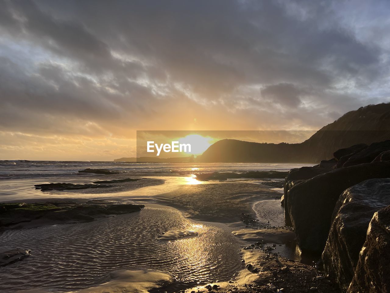 sky, water, sea, land, beach, sunset, coast, beauty in nature, scenics - nature, cloud, ocean, nature, shore, wave, environment, body of water, horizon, landscape, sand, dramatic sky, tranquility, dawn, travel destinations, sunlight, sun, seascape, travel, coastline, tranquil scene, outdoors, rock, wind wave, no people, mountain, evening, motion, holiday, trip, tourism, vacation, idyllic, horizon over water, sports, reflection, summer, non-urban scene, bay, water's edge