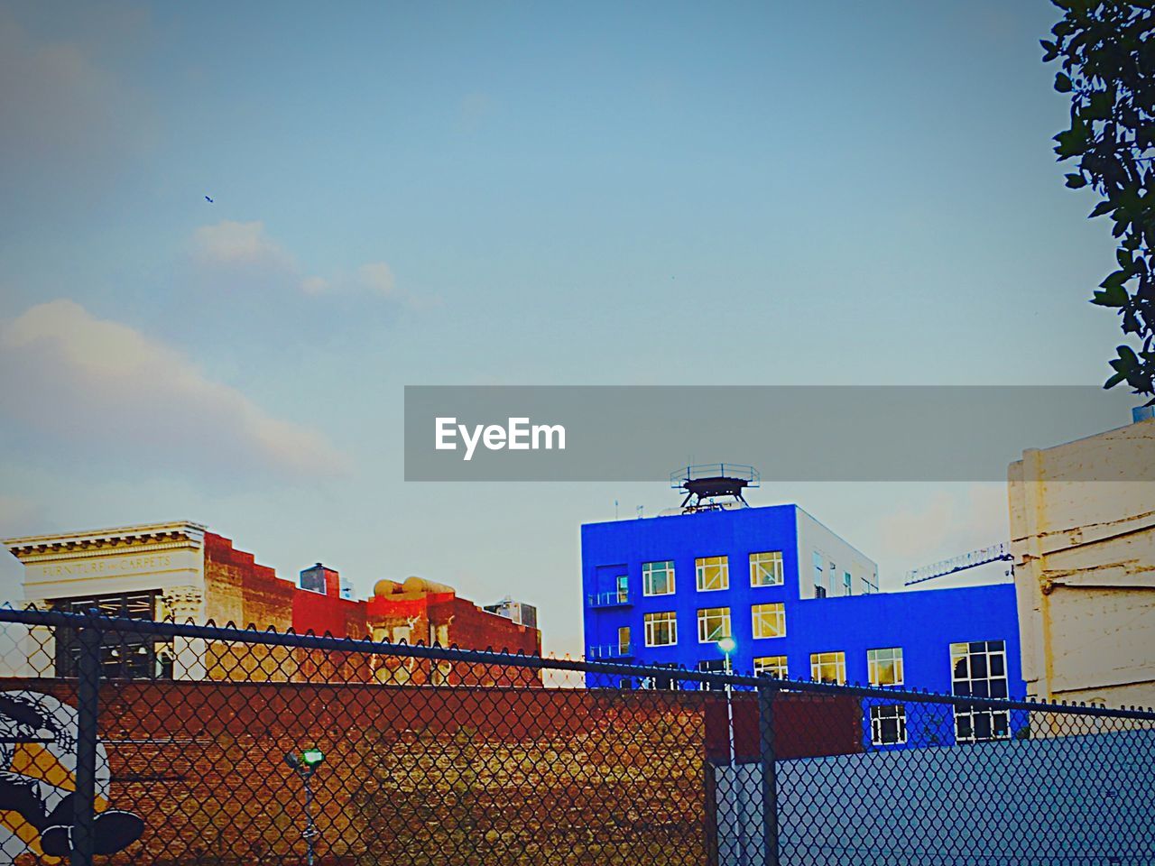 LOW ANGLE VIEW OF BUILDINGS AGAINST BLUE SKY