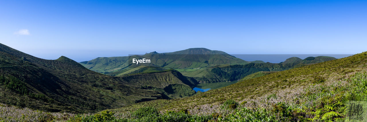 Scenic view of mountains against clear blue sky