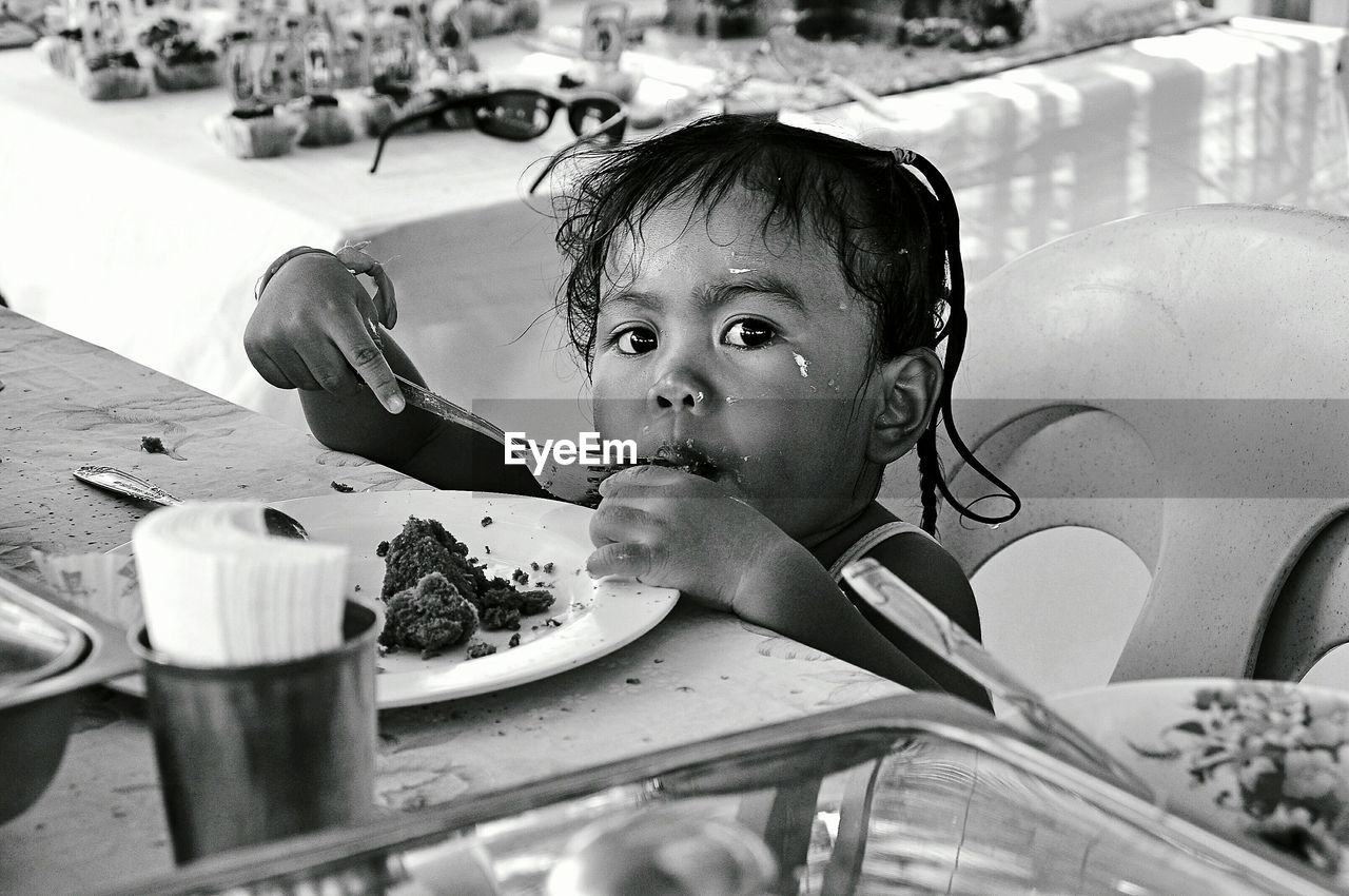 Portrait of cute girl eating food