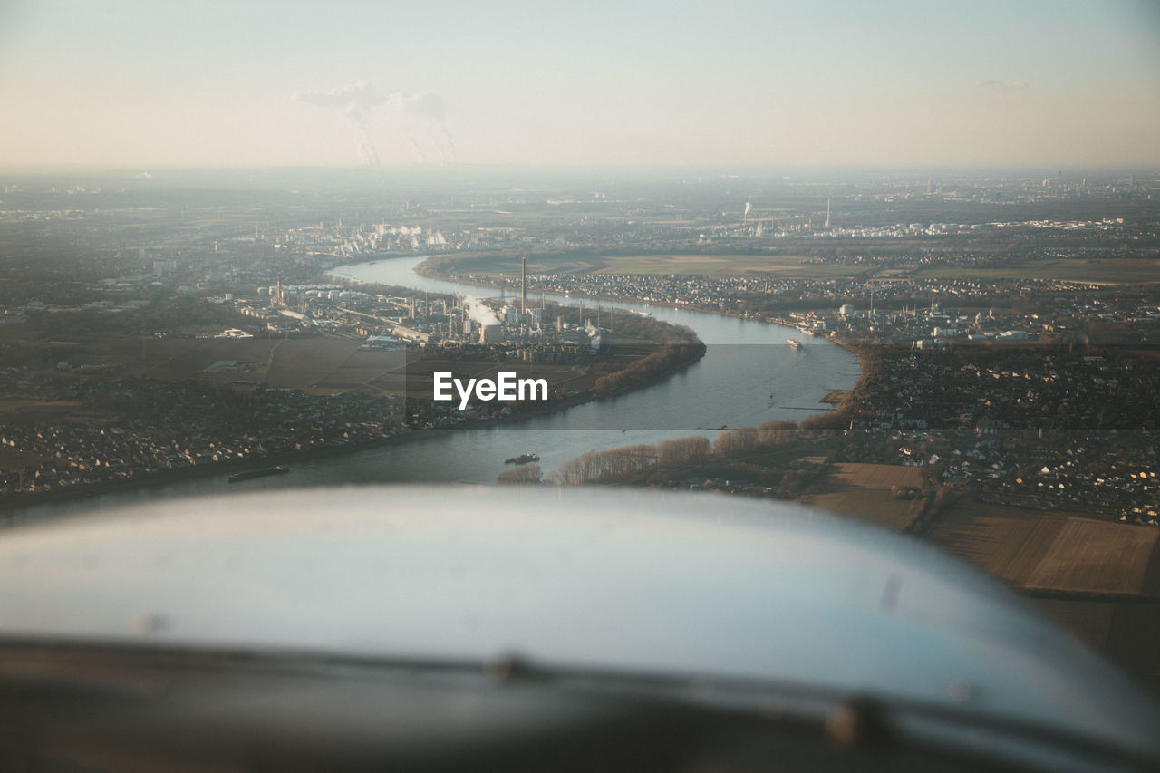 Aerial view of river amidst buildings in city