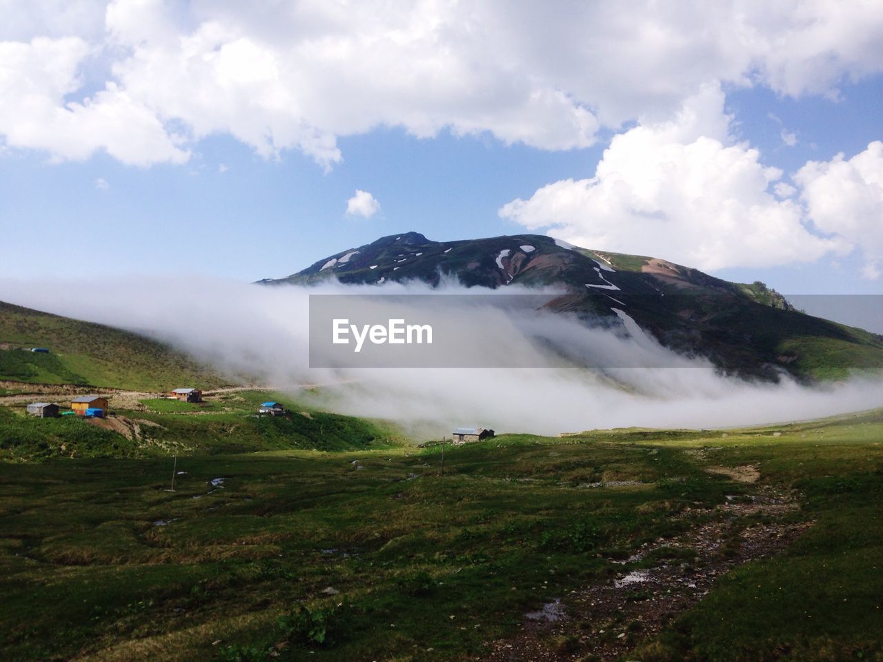 SCENIC VIEW OF MOUNTAINS AGAINST CLOUDY SKY