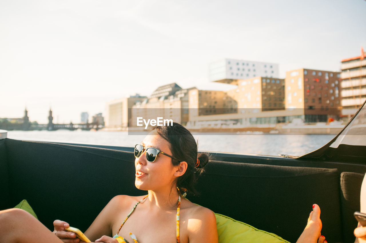 Woman sitting and enjoying in boat at river