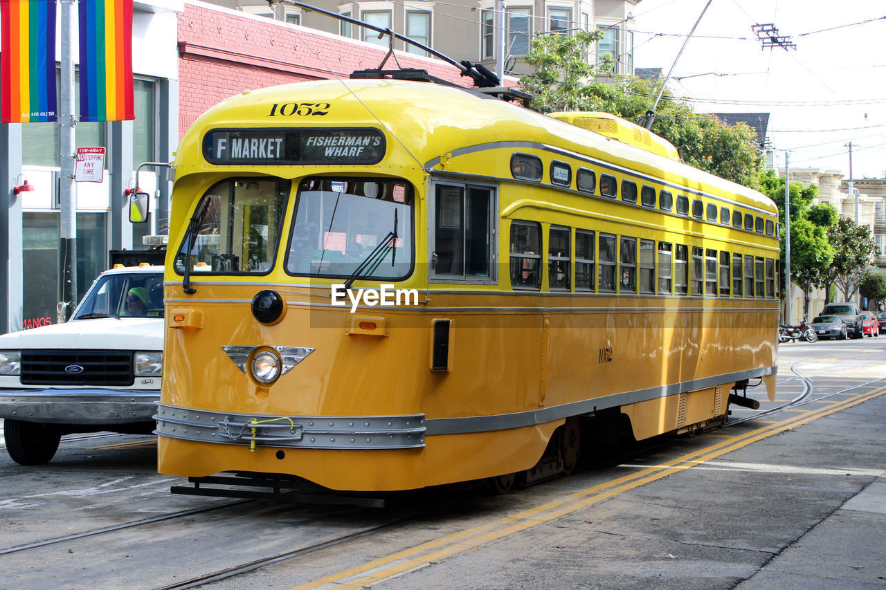 YELLOW TRAIN ON RAILROAD TRACKS