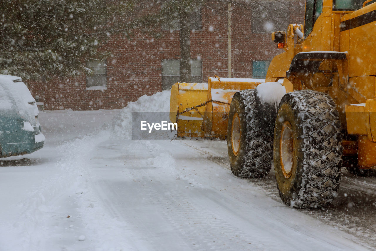 SNOW COVERED ROAD IN CITY