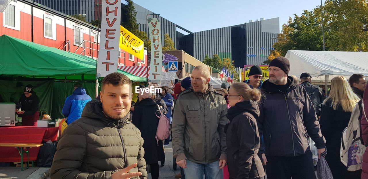 GROUP OF PEOPLE STANDING ON STREET