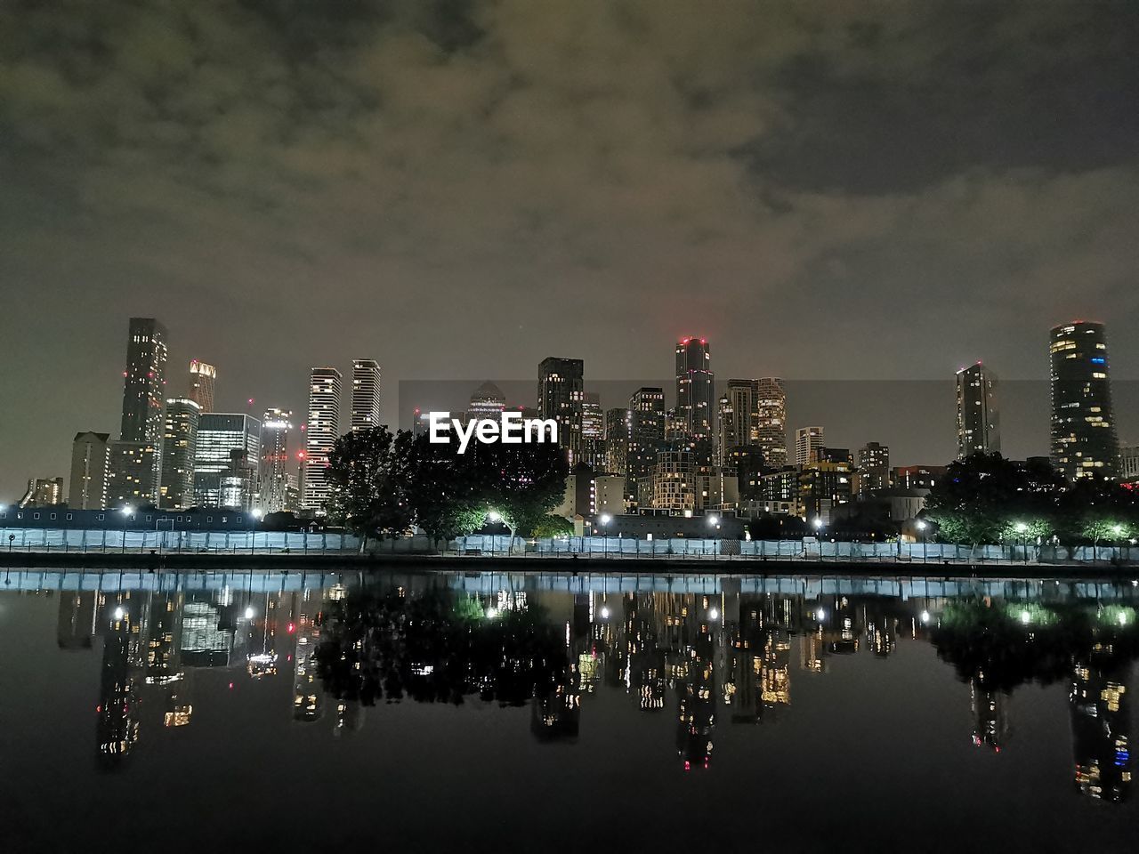 ILLUMINATED BUILDINGS IN CITY AT NIGHT