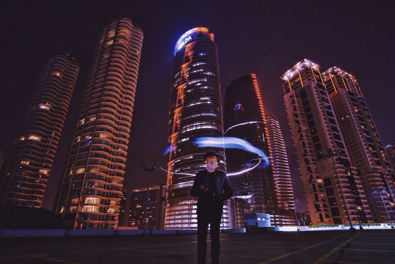 MODERN BUILDINGS IN CITY AT NIGHT