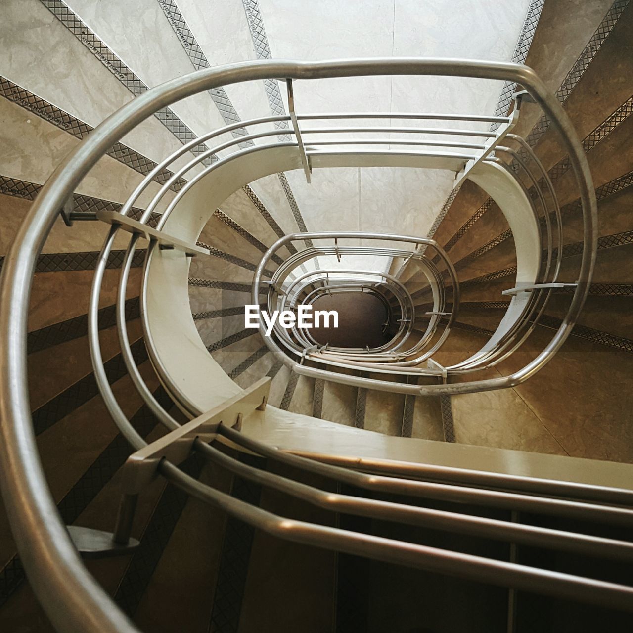 Directly above view of spiral staircase in building
