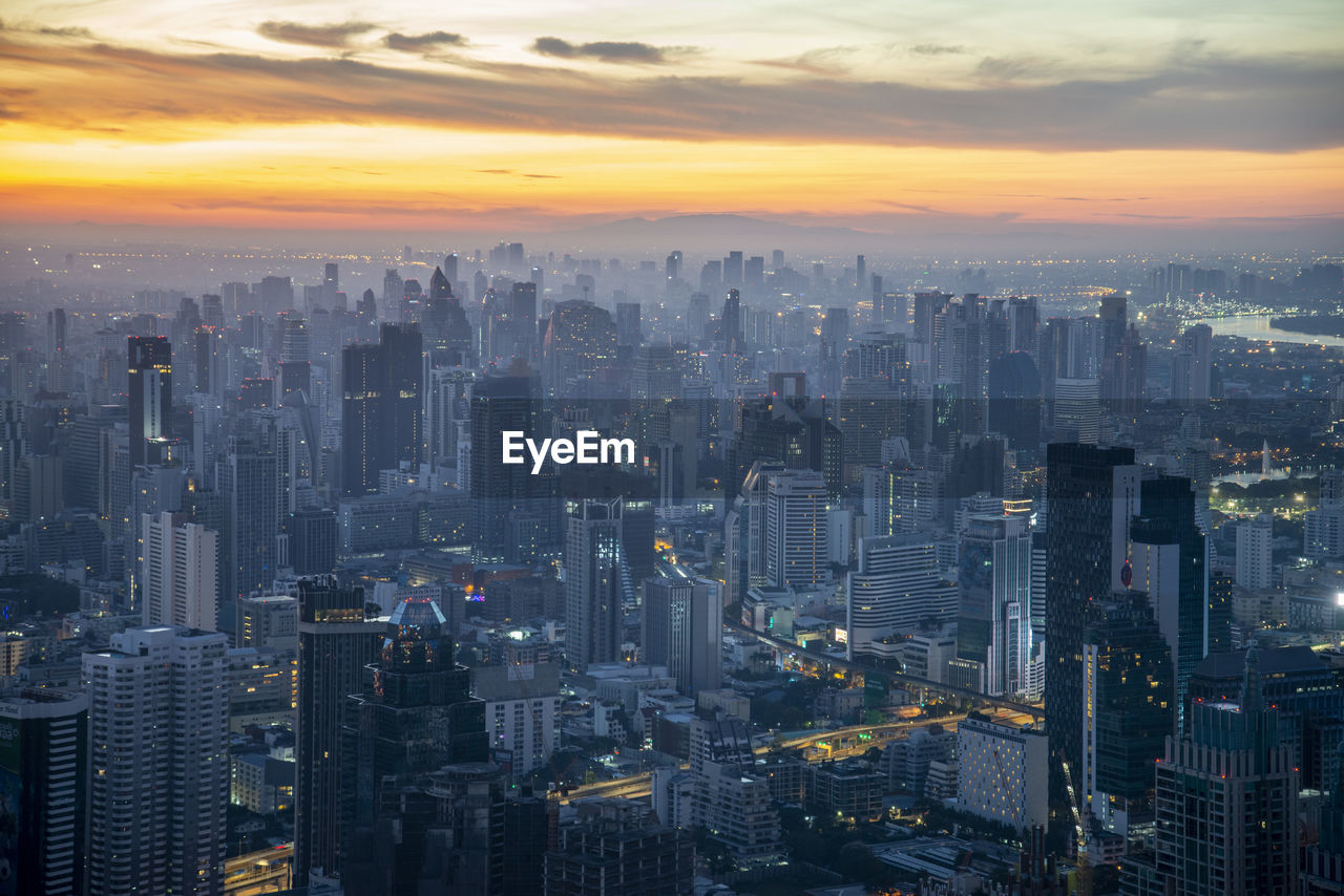 aerial view of city lit at sunset