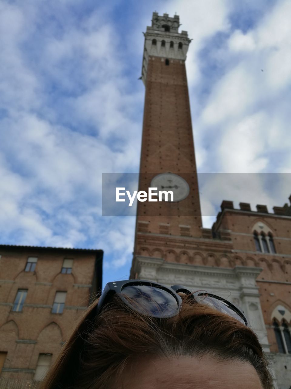 LOW ANGLE VIEW OF CLOCK AGAINST BUILDING