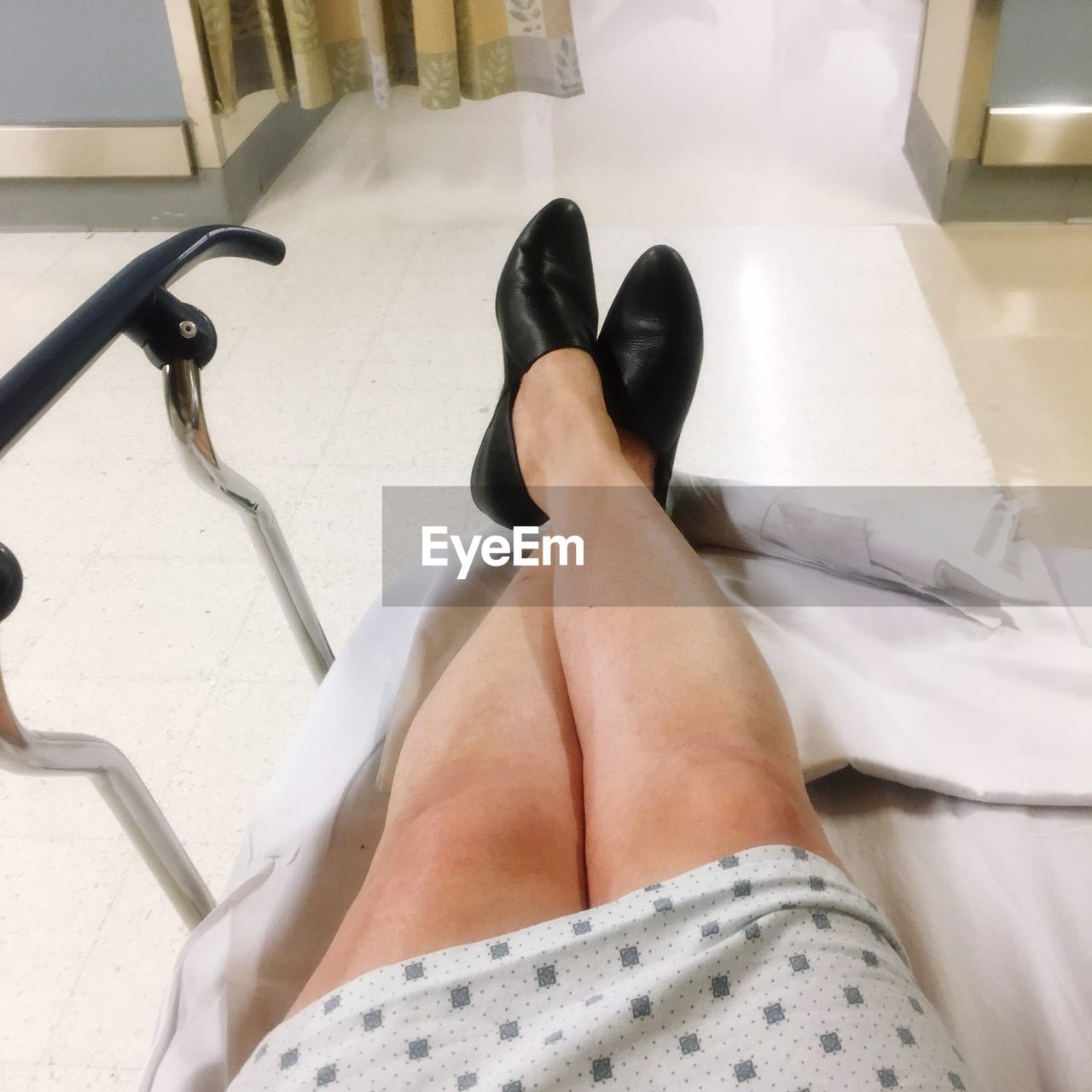 Low section of woman relaxing in hospital