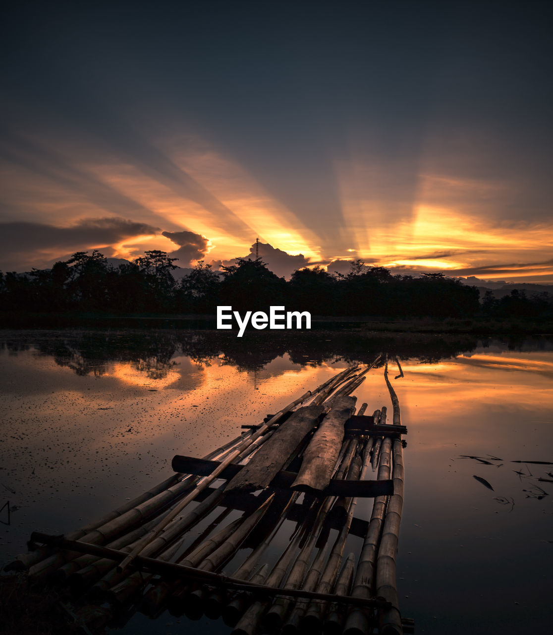 Scenic view of lake against sky at sunset