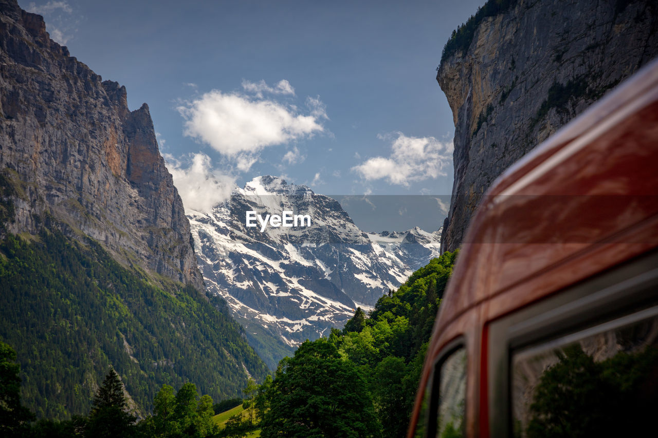 Scenic view of snowcapped mountains against sky with camper van, lauterbrunnen, switzerland.