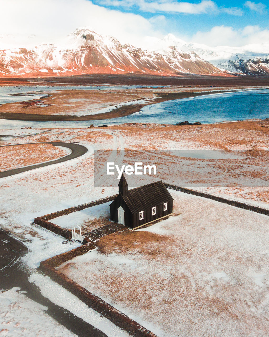 High angle view of house on field against mountains during winter