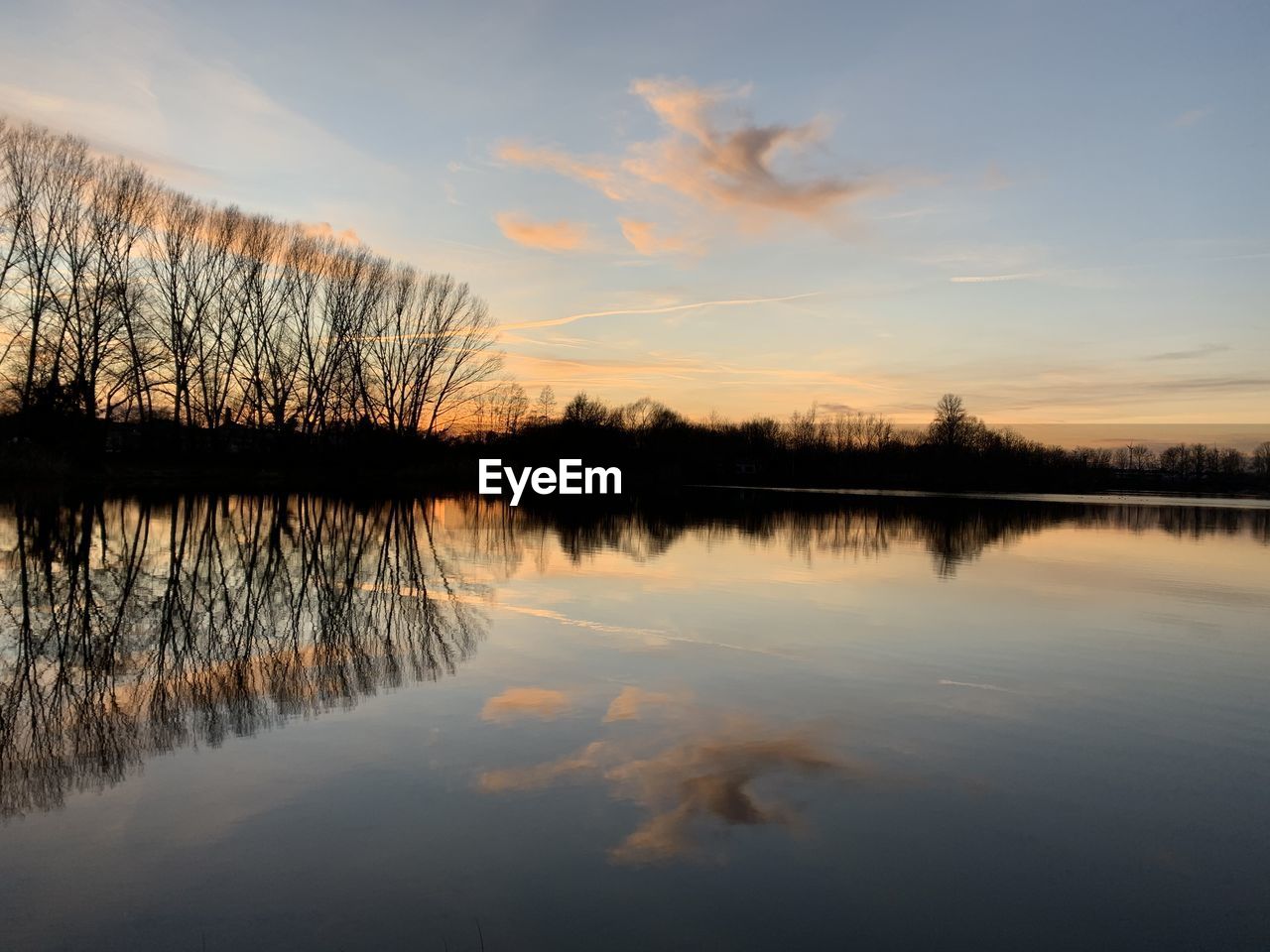 Scenic view of lake against sky during sunset