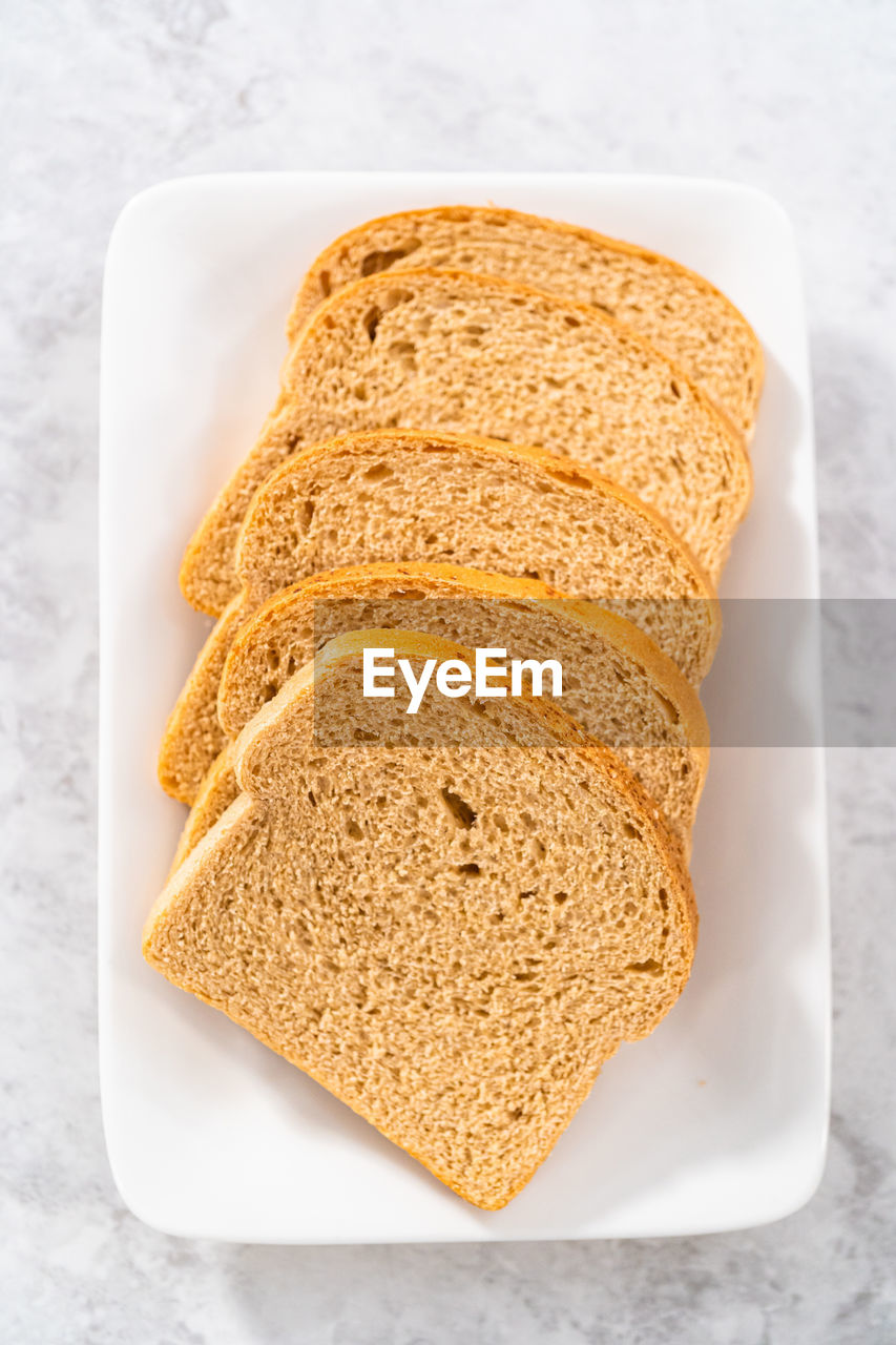 food, food and drink, bread, healthy eating, rye bread, baked, wellbeing, brown bread, freshness, sliced bread, whole grain, studio shot, indoors, breakfast, no people, slice, meal, dessert, high angle view, toasted bread, produce, fast food