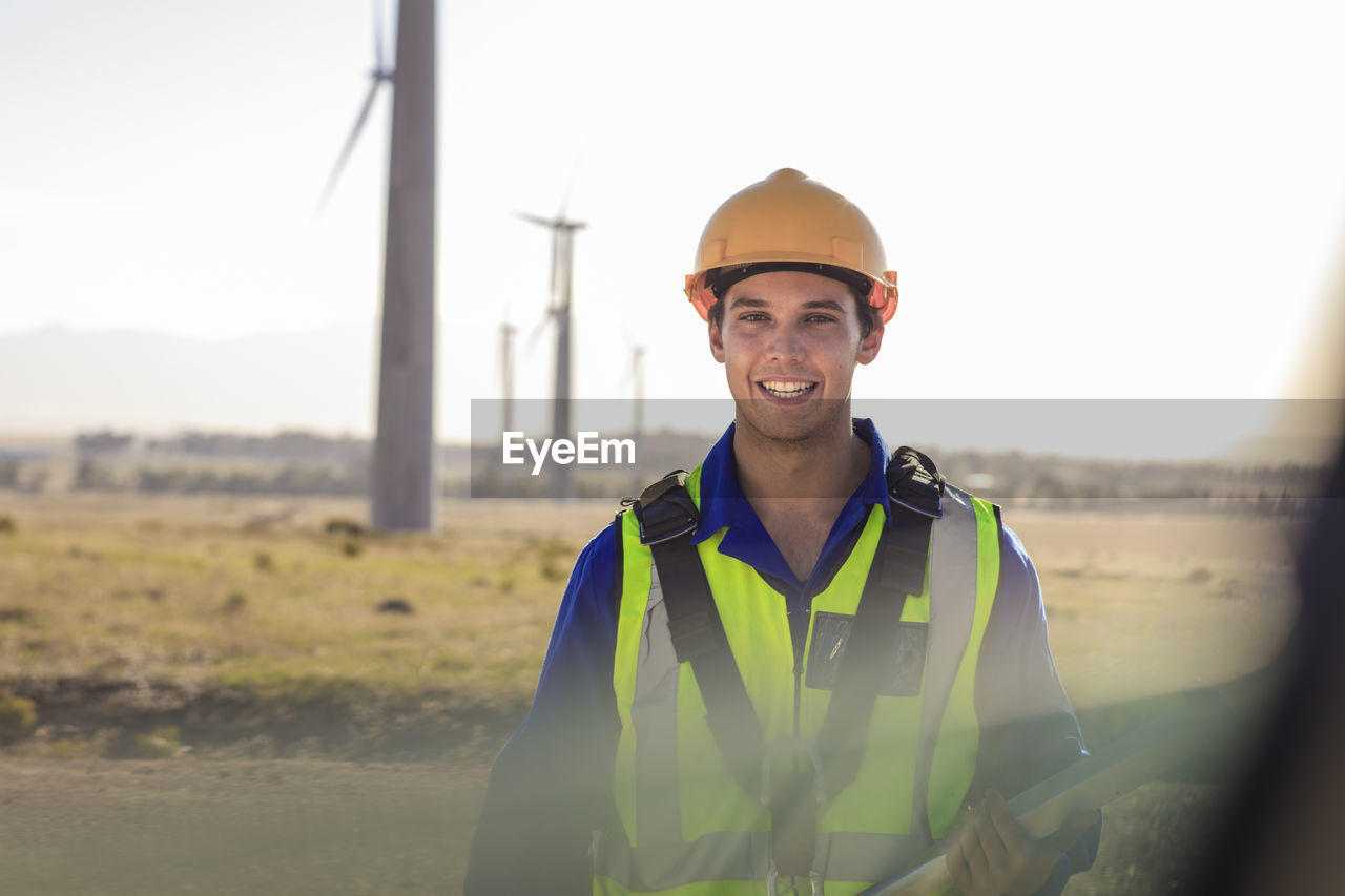 Portrait of smiling technician on a wind farm