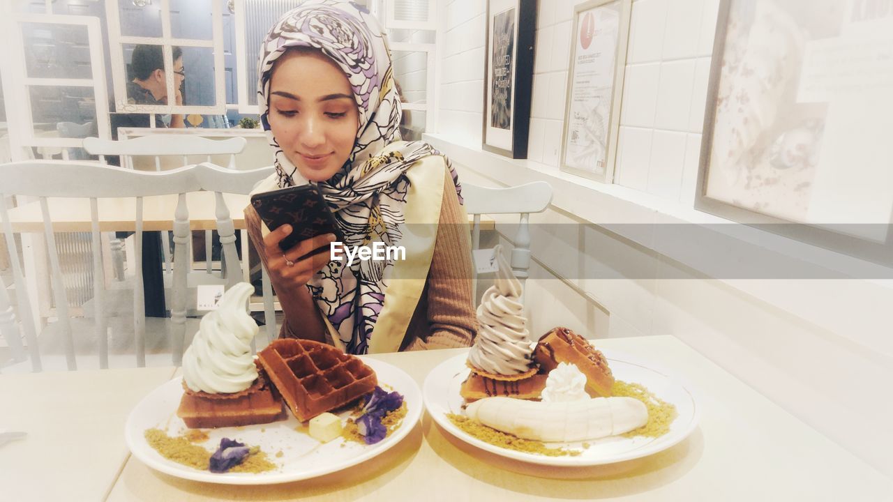 YOUNG WOMAN LOOKING AT ICE CREAM