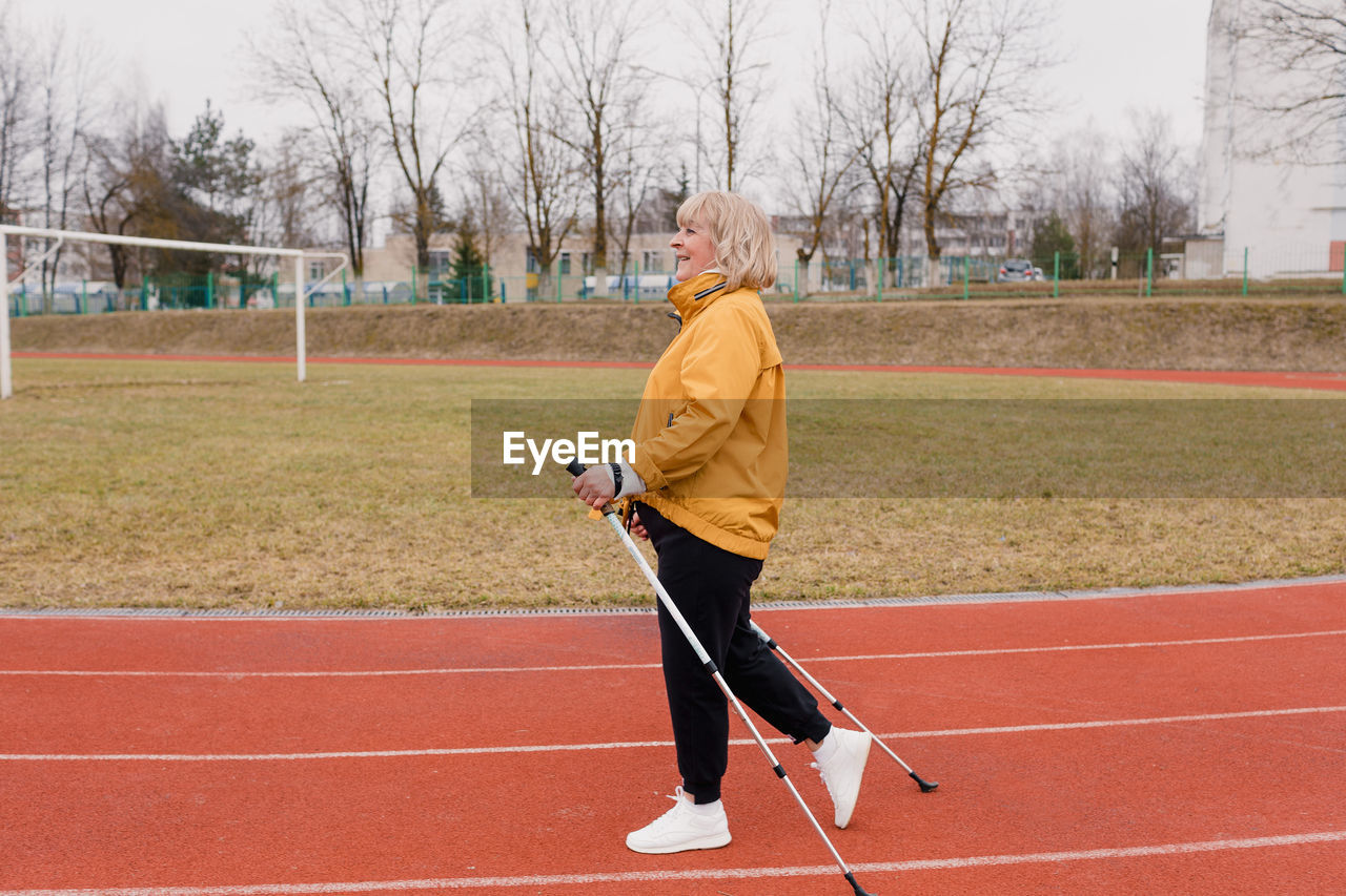 Side view of woman standing on field