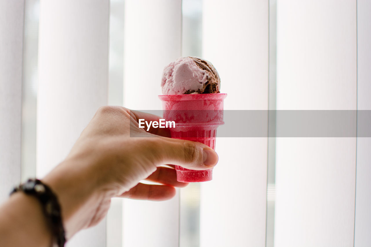 Cropped hand holding ice cream