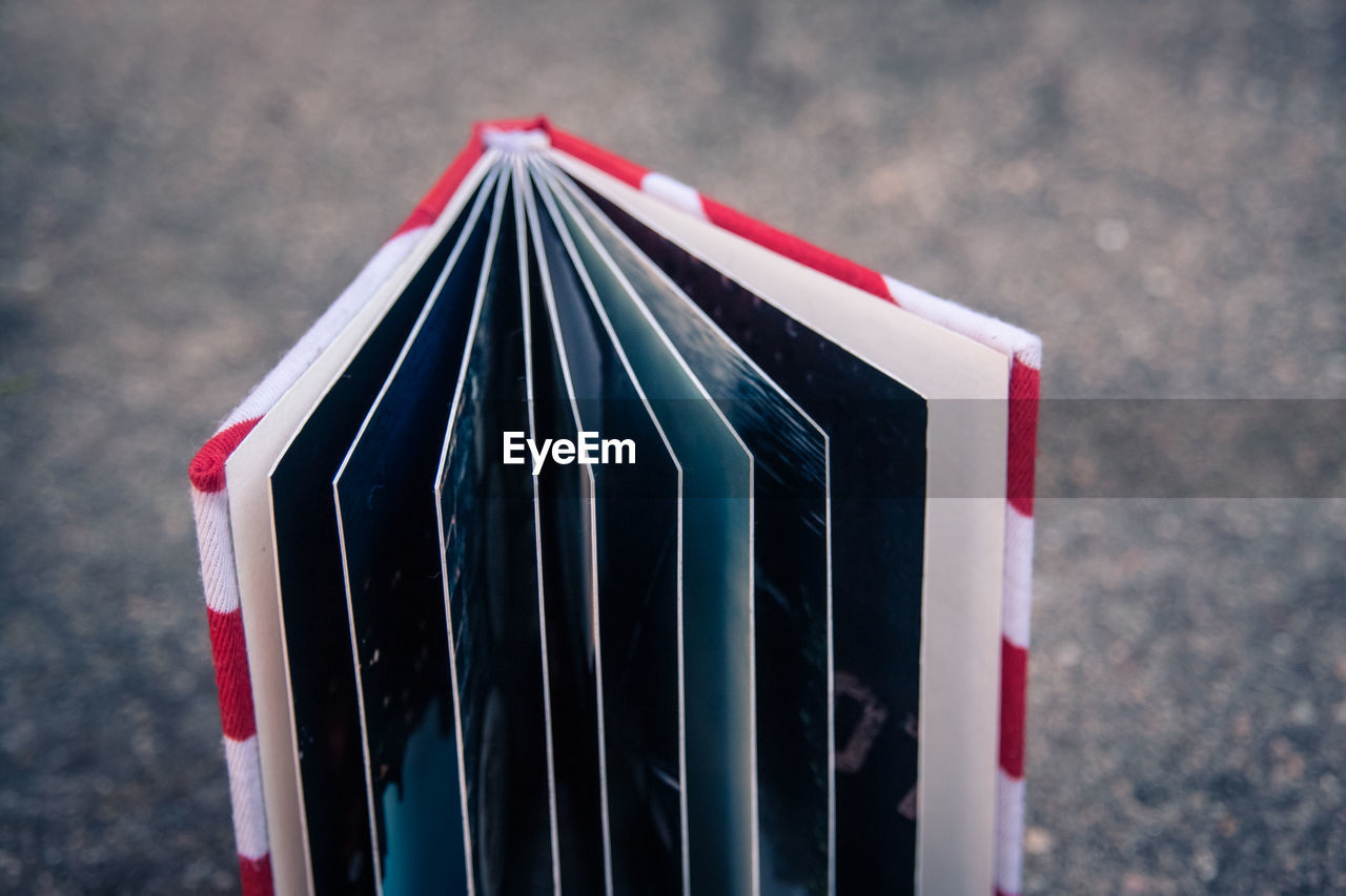 Close-up of hardcover book on road