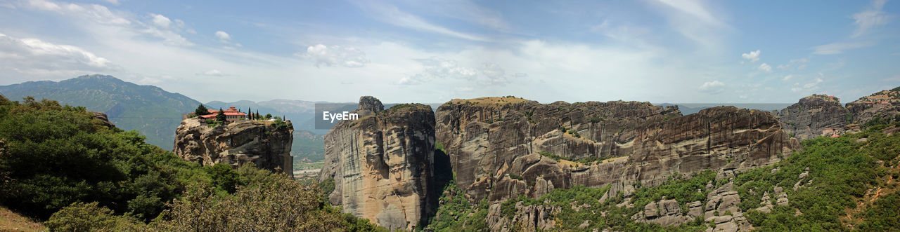 PANORAMIC VIEW OF ROCKS AND PLANTS AGAINST SKY