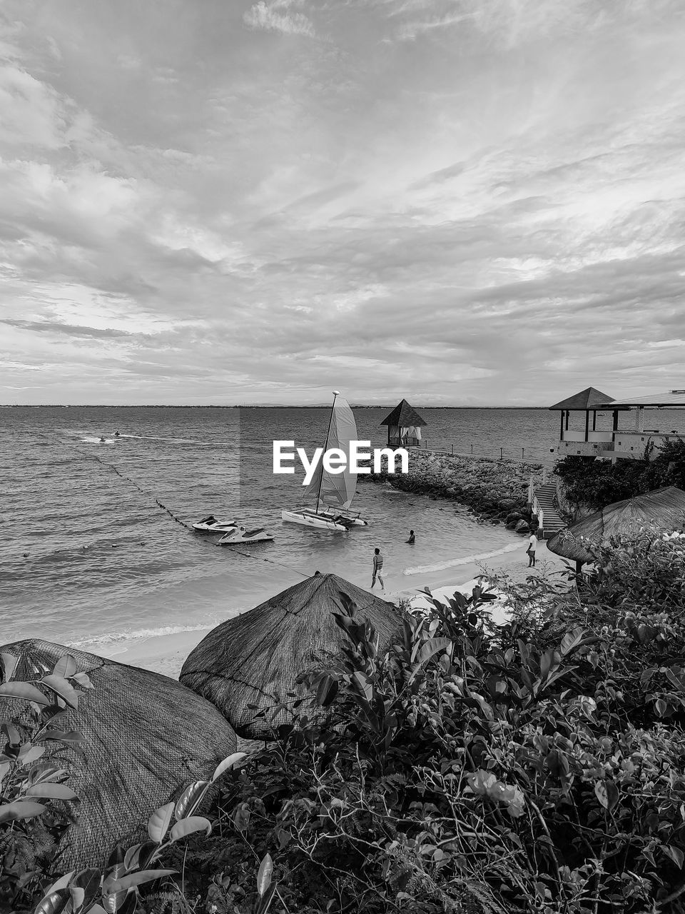water, sea, sky, beach, land, black and white, nature, coast, shore, cloud, scenics - nature, monochrome photography, monochrome, beauty in nature, horizon over water, horizon, ocean, tranquility, wave, sand, tranquil scene, no people, day, travel destinations, environment, outdoors, travel, rock, architecture, plant, coastline, holiday, non-urban scene, trip, vacation, nautical vessel, white, tourism, landscape, hut, built structure, seascape