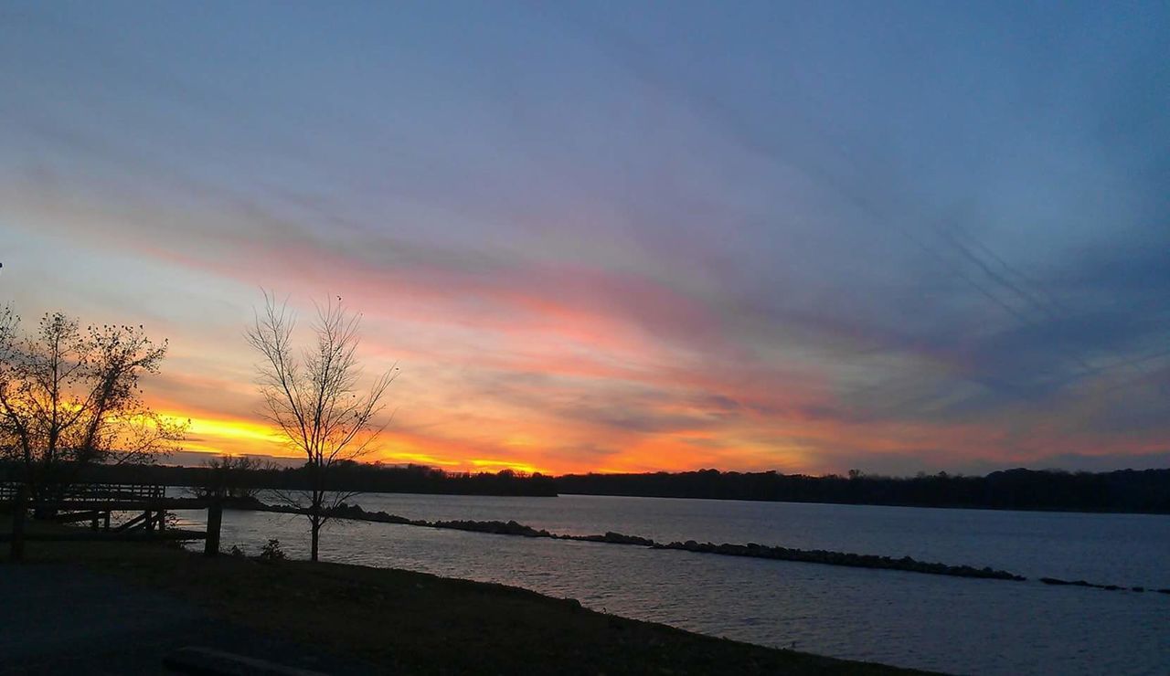 SCENIC VIEW OF BEACH AGAINST SKY AT SUNSET