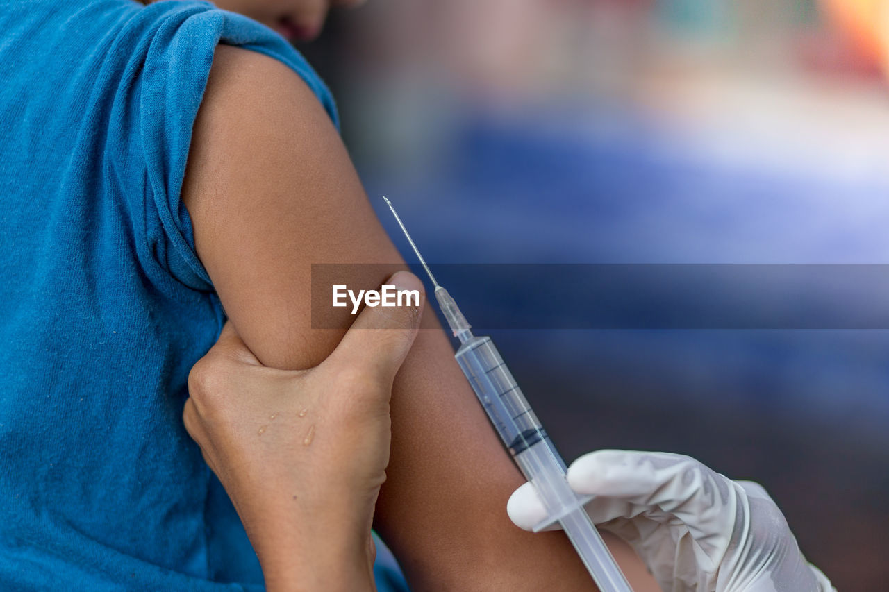 Close-up of doctor giving injection to patient