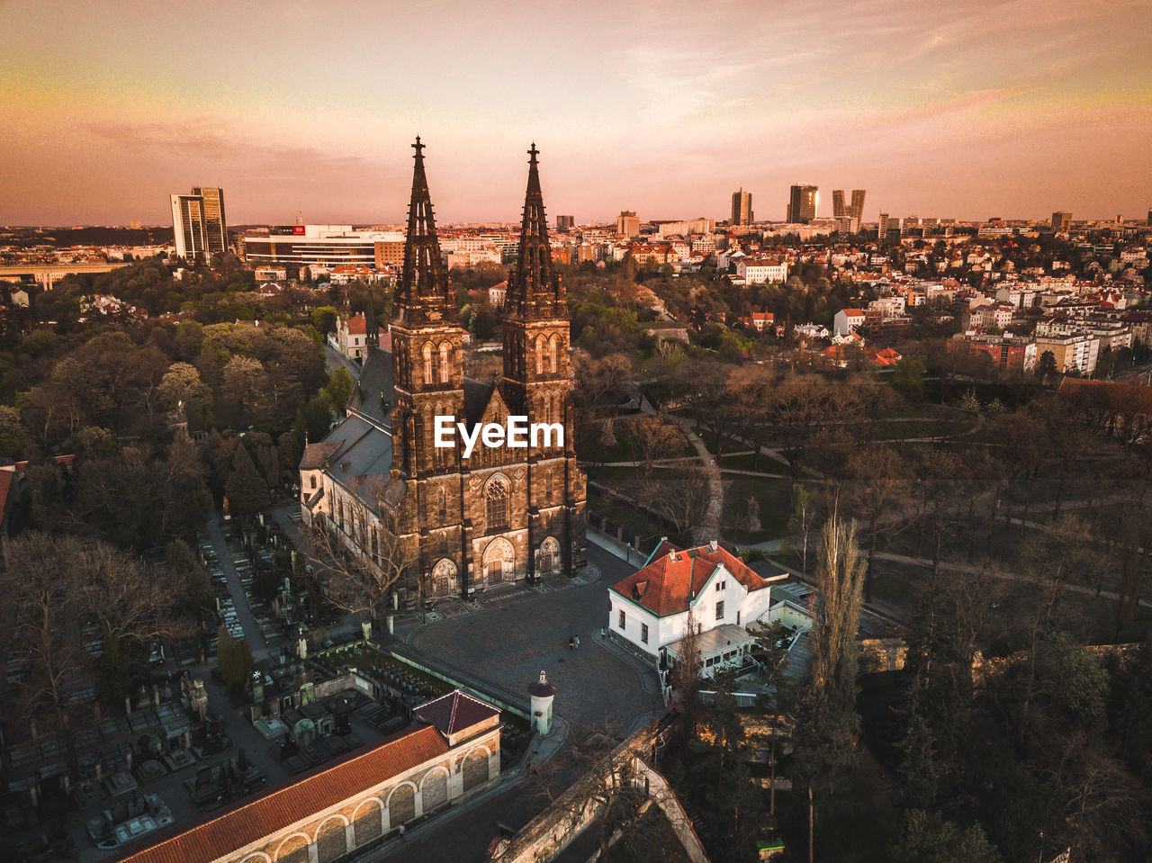 High angle view of illuminated buildings in city at sunset