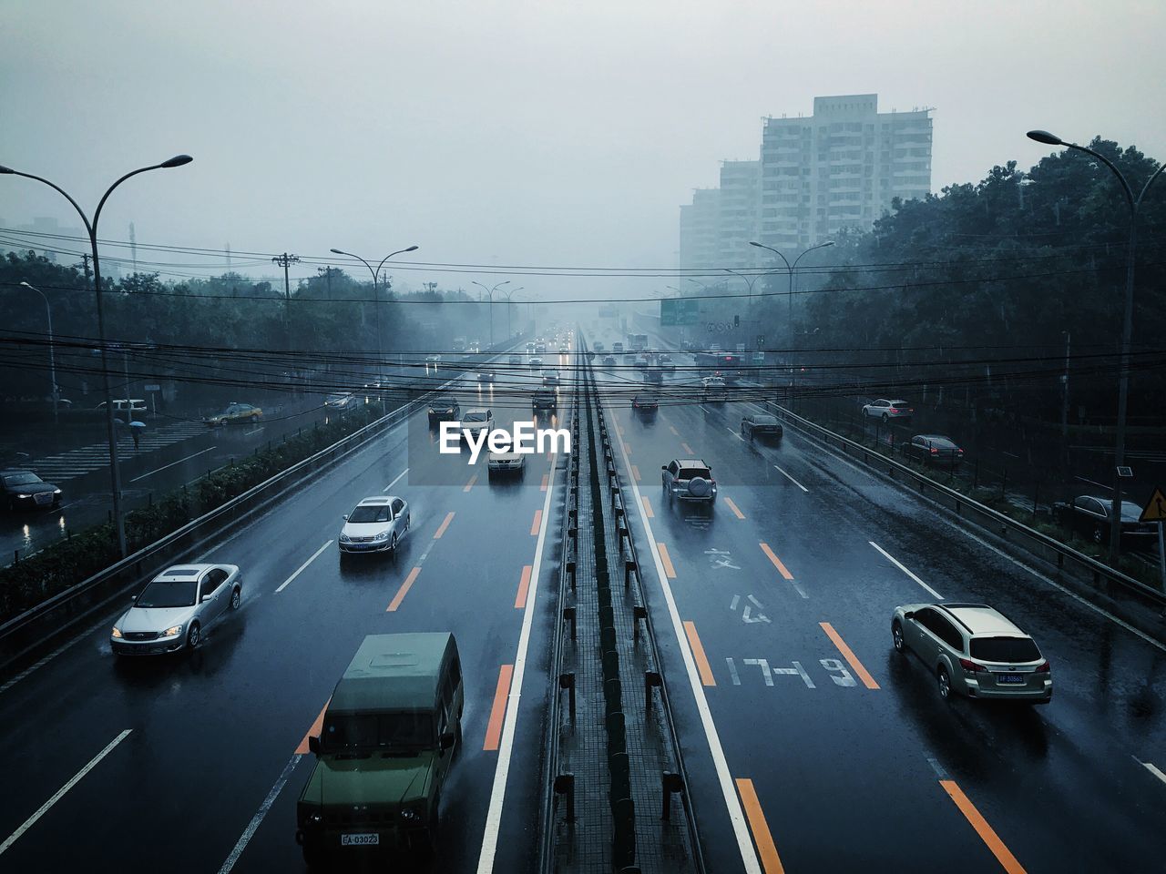 Traffic on city street against sky