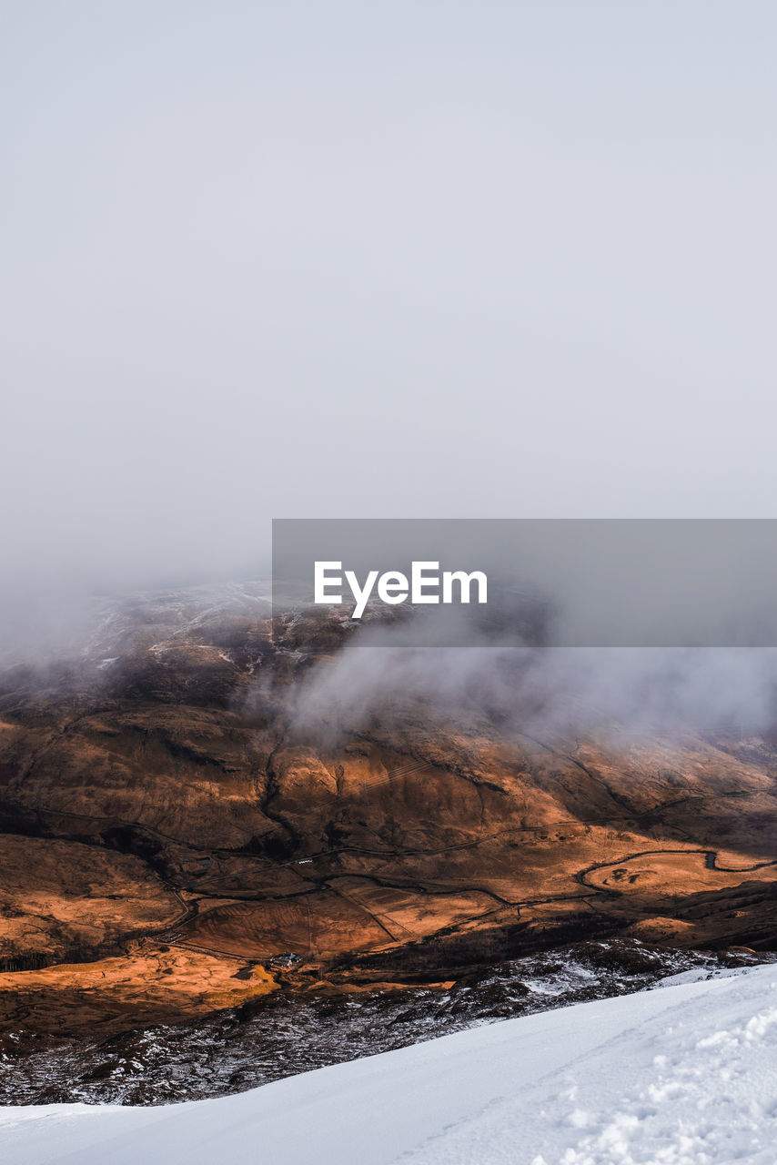 Scenic view of mountains against sky during winter