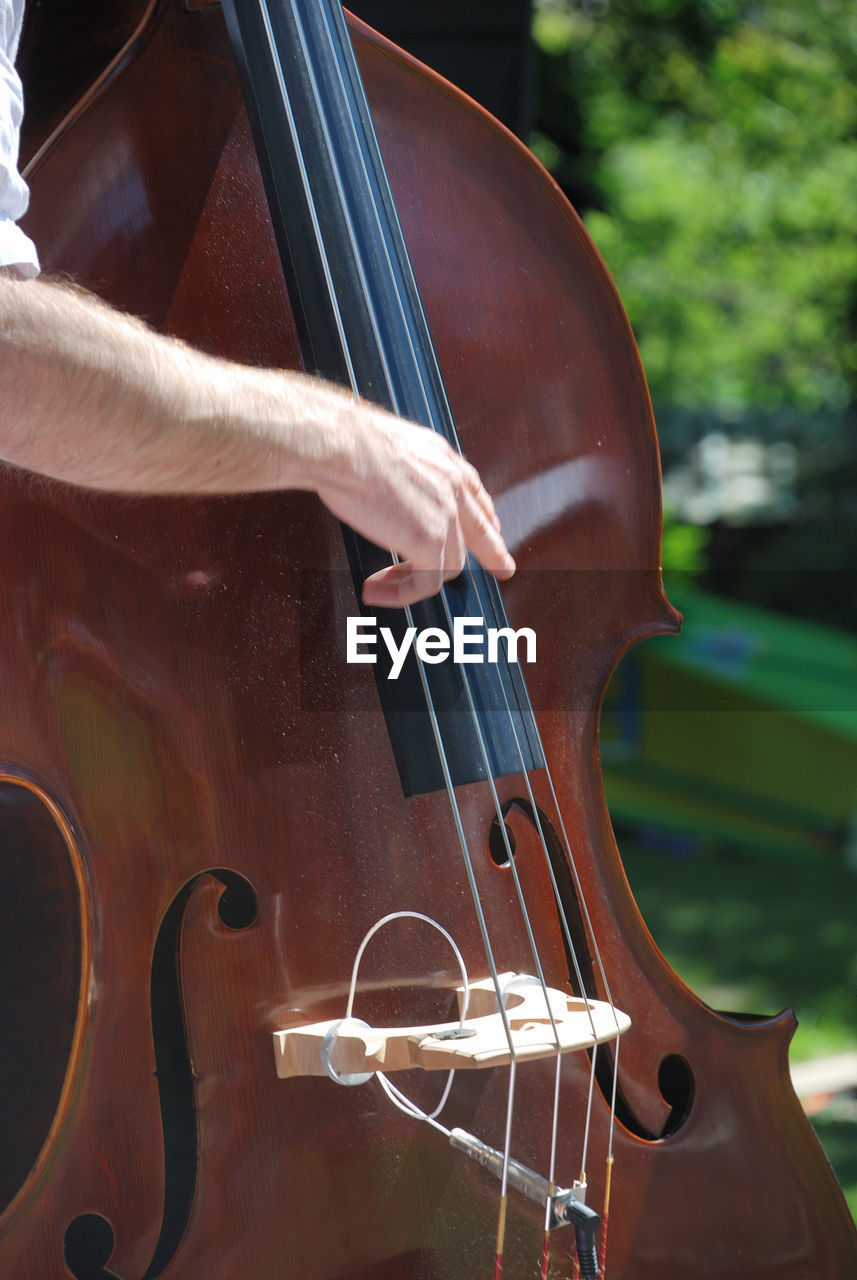 Cropped hand of man playing cello