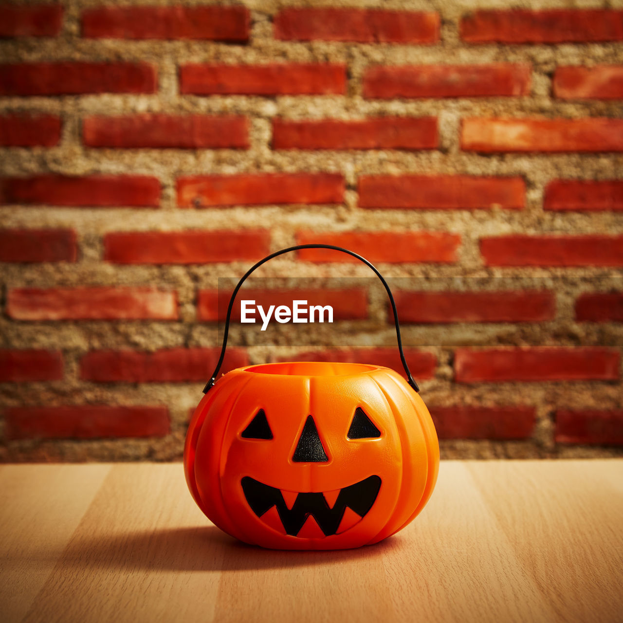 CLOSE-UP OF PUMPKIN ON RED TABLE