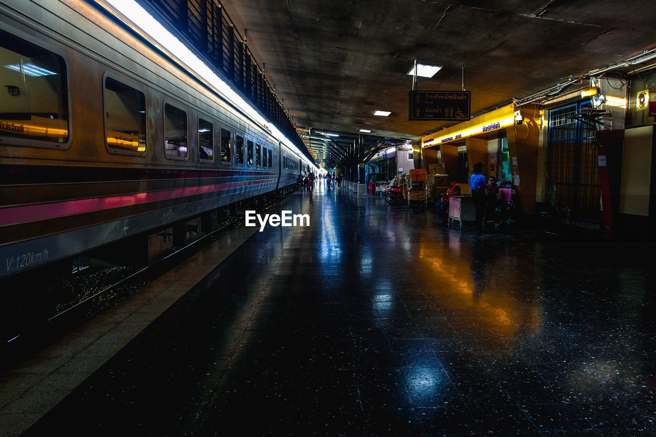 ILLUMINATED RAILROAD STATION PLATFORM AT NIGHT