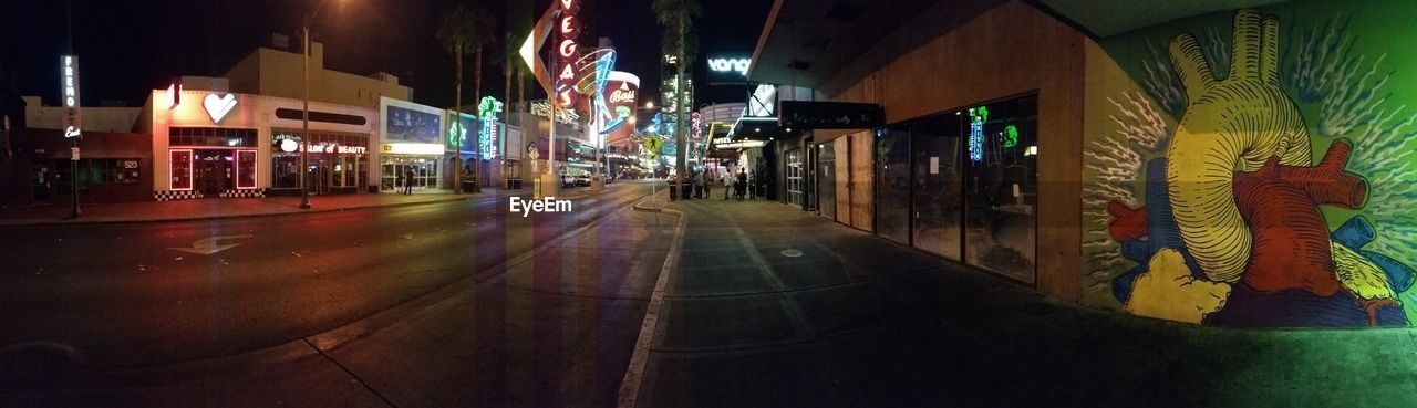 NIGHT VIEW OF ILLUMINATED CITY STREET AT NIGHT