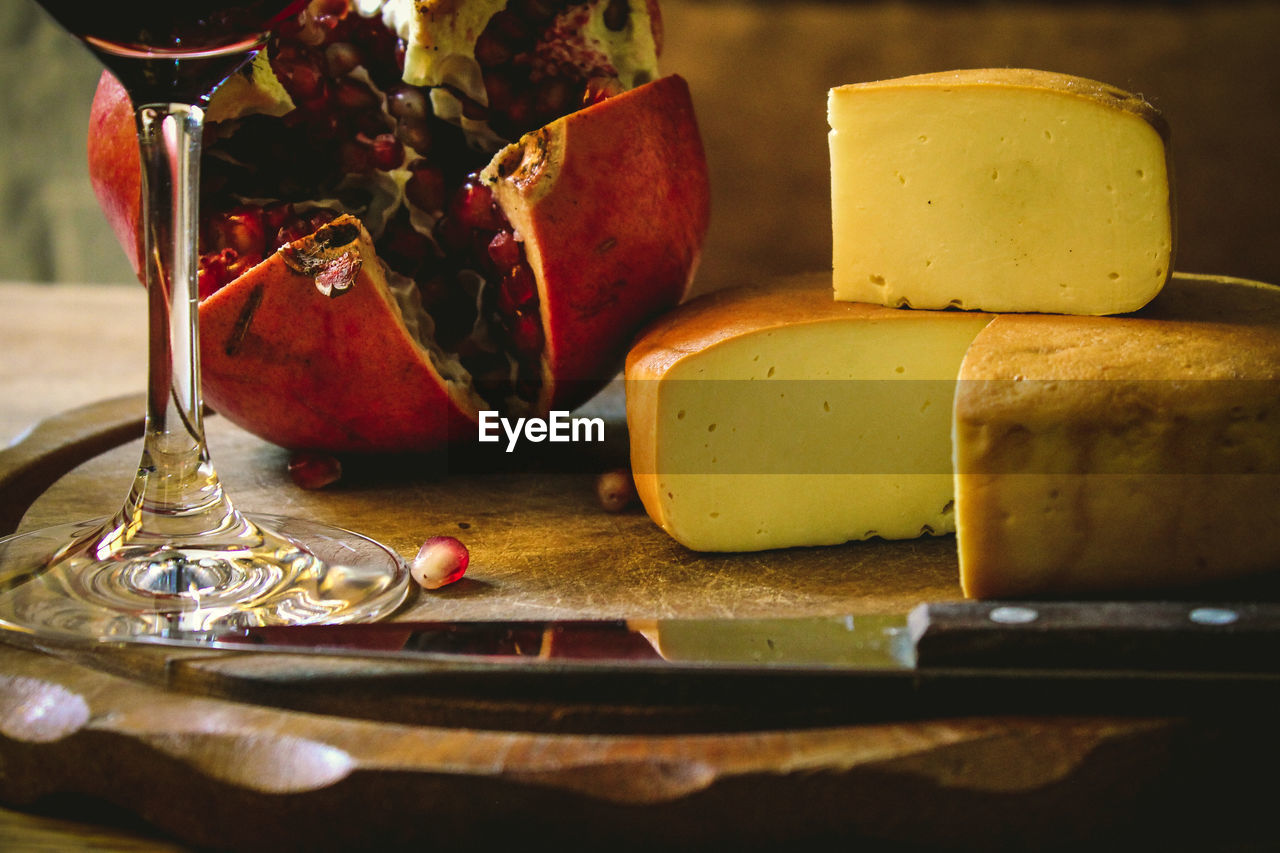 Close-up of cheese with pomegranate in plate on table